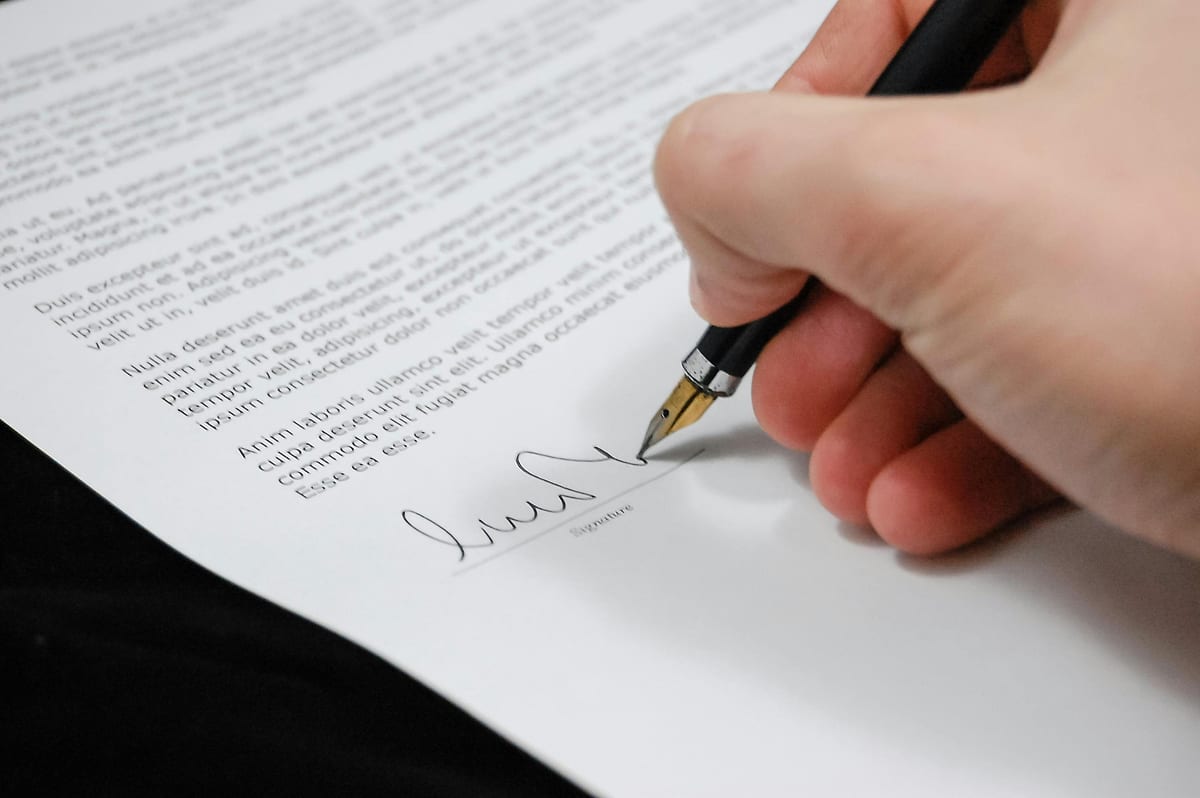 Someone signing a document